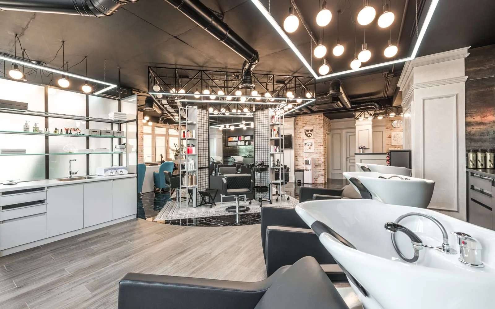 Backwash chairs with sinks placed in spacious modern beauty salon with stylish design and various cosmetology products with professional equipment