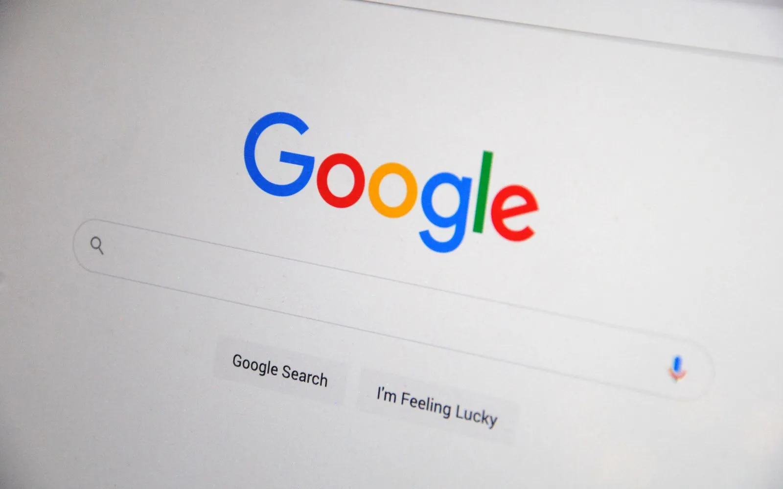 Close-up of the Google homepage on a screen showing search options.