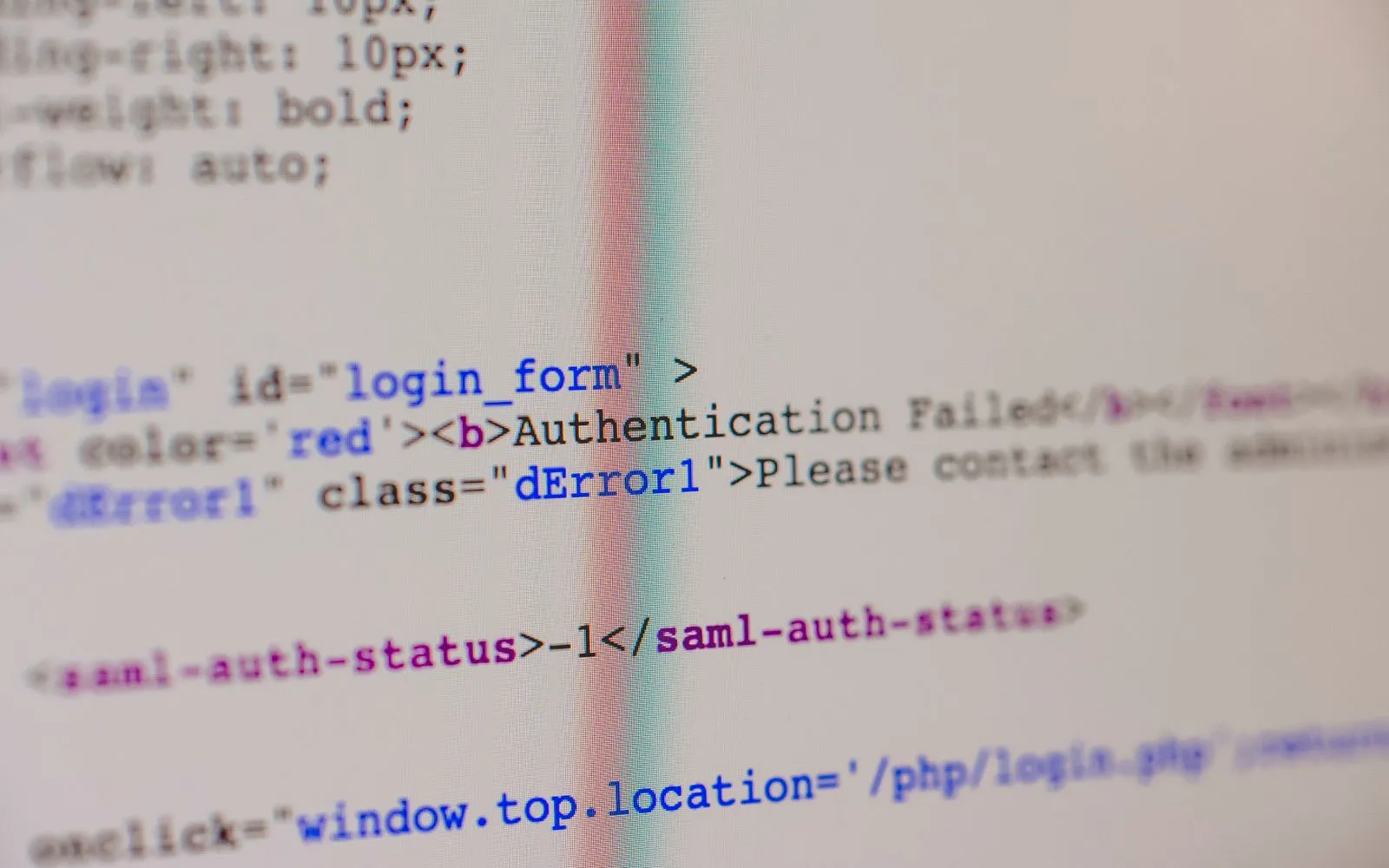 Close-up of HTML and PHP code on screen showing error message and login form data.